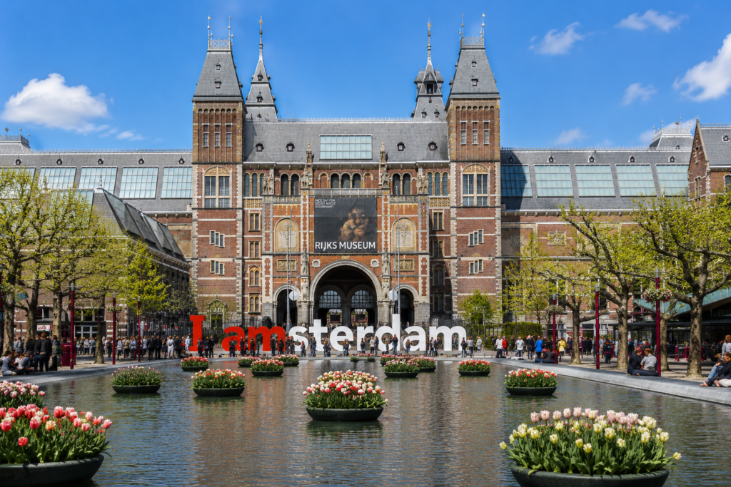 Front view of the Rijksmuseum in Amsterdam with the famous museum square and visitors