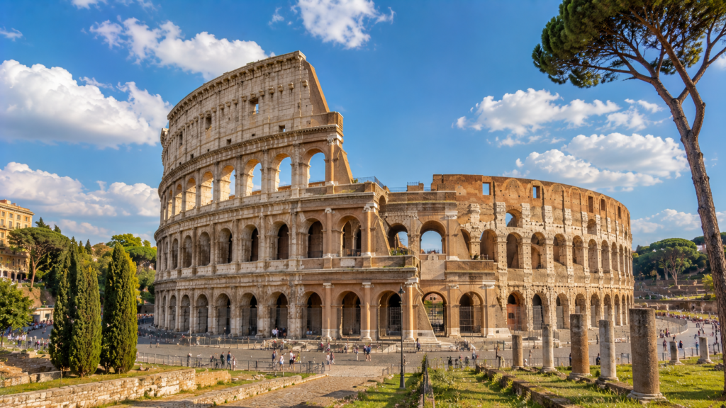 Colosseum surrounded by ancient ruins and Mediterranean pine trees in Rome, Italy