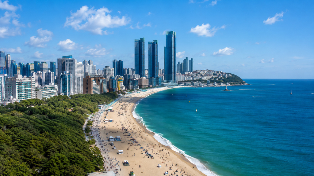 Haeundae Beach and the modern coastal skyline of Busan, South Korea on a bright afternoon