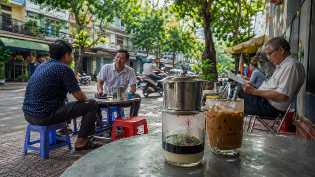 Vietnamese coffee culture at a busy sidewalk café in Ho Chi Minh City with traditional phin coffee